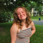 Headshot of Vivero Fellow Kailee Shermak on a lawn in front of green trees